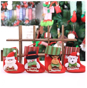 Detail of four festive Christmas stockings with Santa, Snowman, Reindeer, and Bear motifs