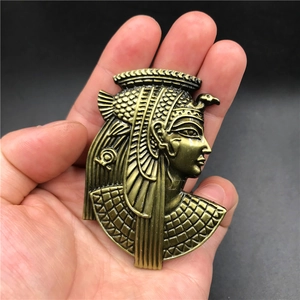 Detailed macro view of 3D embossed antique gold Egyptian Pharaoh metal fridge magnet