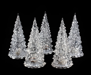 Close-up of five transparent crystal Christmas tree night lights on black background