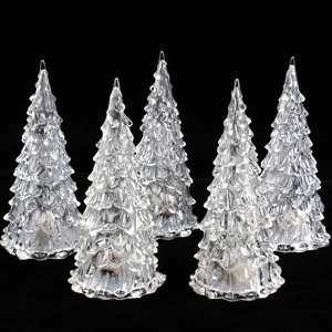 Luminous colorful crystal Christmas trees with transparent finish on a black background