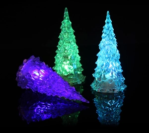 Detailed view of LED glowing crystal Christmas trees in purple, green, and blue colors