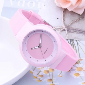 Pink minimalist quartz watch with silicone strap displayed on a decorative floral background