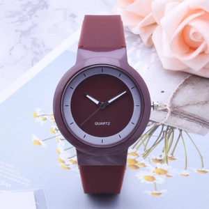 Minimalist burgundy silicone quartz watch with white markers on a floral background