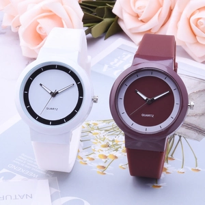 Detailed close-up of white and burgundy silicone quartz watches with matte finish and soft roses