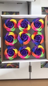 Detailed top view of 9 rainbow soap roses neatly arranged in a cardboard gift box