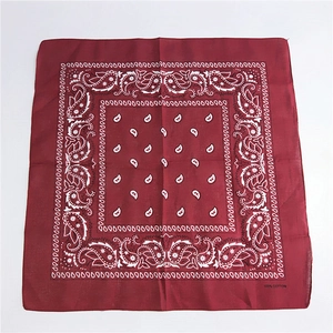 Deep red cotton square scarf featuring classic white paisley patterns displayed on white background