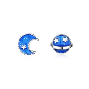 Asymmetric blue planet and moon stud earrings with silver accents on a white background