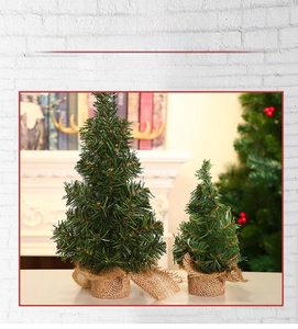 Mini artificial Christmas trees with burlap-wrapped bases for festive tabletop decor