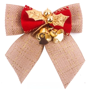 Macro detail of Christmas burlap bow with gold threads, red velvet, and small golden bells