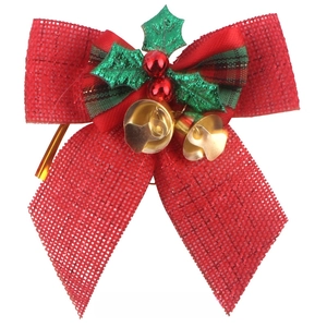 Macro shot of red burlap Christmas bow featuring golden bells and holly berry details