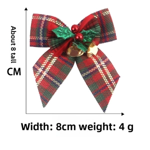 Detailed view of 8cm plaid Christmas bow with golden bells and green holly leaves
