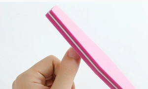 Close-up of a pink high-elastic foam nail buffer with white core and matte texture