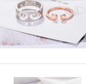 Detailed view of silver and rose gold 925 sterling silver hollow wave patterned rings