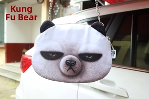 Detail view of panda crossbody bag with grumpy expression and metal chain strap