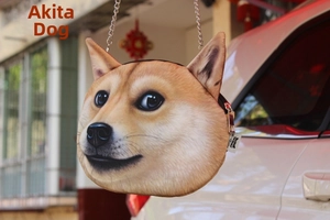 Detail of Akita dog plush crossbody bag with silver metal chain and brand label