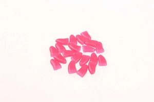 Close-up of 20 rose red silicone pet nail caps for cats and dogs on white background