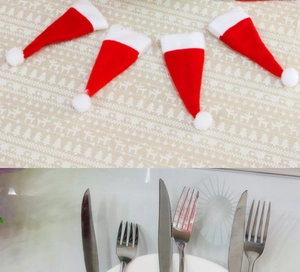 Detail view of 4-pack mini Santa hats for silverware decor on festive table settings