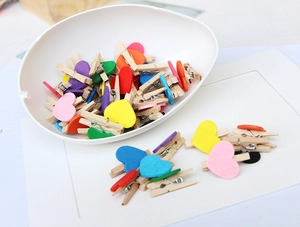 Close-up of colorful wooden heart clips in various vibrant colors for home decoration