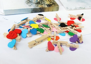 Macro shot of 3.5cm colorful wooden photo clips with painted heart decorations