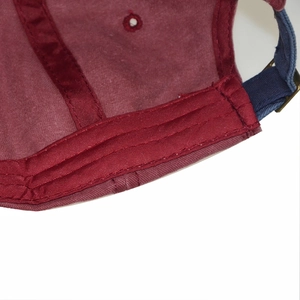 Detail view of washed cotton baseball cap featuring reinforced seams and metal buckle