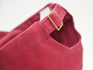 Close-up of cotton baseball cap rear view with adjustable bronze metal buckle and strap