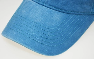 Close-up of turquoise washed cotton baseball cap brim with five-row neat stitching