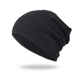Detailed view of black slouchy beanie featuring a fine horizontal knit texture and layers