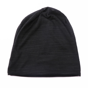 Detailed view of black slouchy beanie featuring a fine horizontal knit texture and soft fabric
