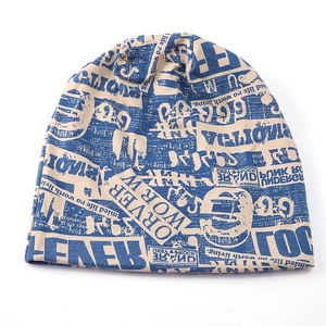 Unisex knit slouchy beanie featuring vintage newspaper letter print in beige and navy