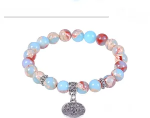 Detail of multi-color stone beads bracelet featuring a vintage silver Tree of Life charm