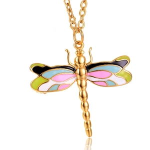 Macro shot of a golden dragonfly pendant featuring colorful enamel wings and a matching chain