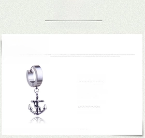 Macro detail of a polished stainless steel anchor earring in punk nautical style