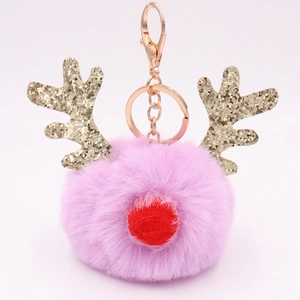 Detail view of pink plush reindeer keychain with gold glitter antlers and metal hook