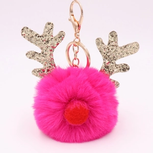 Detail of rose red plush ball keychain with golden sequin antlers and metallic keyring