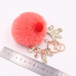 Pink sequin reindeer plush keychain with gold antlers and size measurement scale