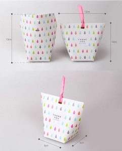 Detailed view of colorful raindrop paper gift bags with pink ribbon and size labels
