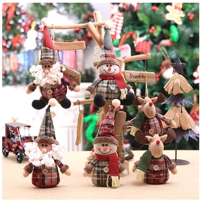 Detail of Christmas tree ornaments featuring Santa, Snowman, and Reindeer in plaid fabric