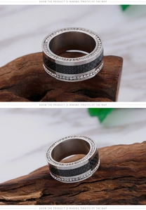 Macro shot of stainless steel ring with black carbon fiber and double row zircon stones