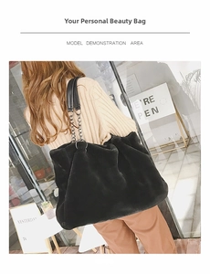 Detail of black faux fur tote bag with silver chain and leather shoulder strap