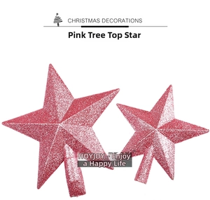 Detail of pink glittered Christmas tree toppers with reflective star finish and base