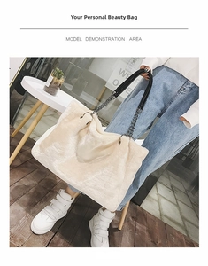Detail of plush tote bag with cream faux fur texture and leather chain strap handles