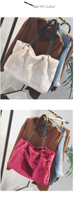 Detailed view of plush faux fur tote bags in beige and rose red with metal chain straps