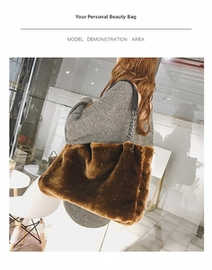 Detail view of brown faux fur tote bag with black leather and metal chain straps
