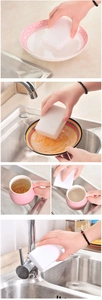 Detail showing multi-use nano sponge cleaning a pink plate, bowl, and metal faucet