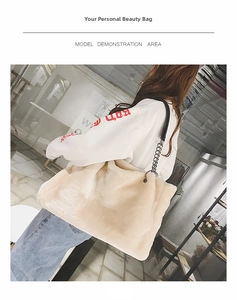 Detailed macro view of cream faux fur tote bag with black leather and silver chain strap