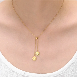 Golden titanium steel necklace with sunflower pendants and zircon worn by a model