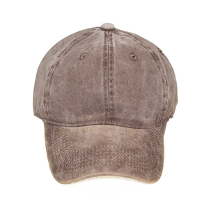 Detail view of washed cotton fabric and embroidery eyelets on a dark brown baseball cap