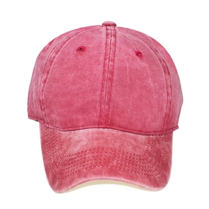 Detail of vintage washed red cotton kids baseball cap with stitched panels and top vents