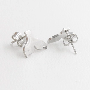 Polished silver stainless steel mermaid whale tail stud earrings for women on white surface