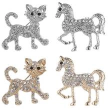 Detail of four-piece brooch set with cat and horse shapes in gold and silver finishes